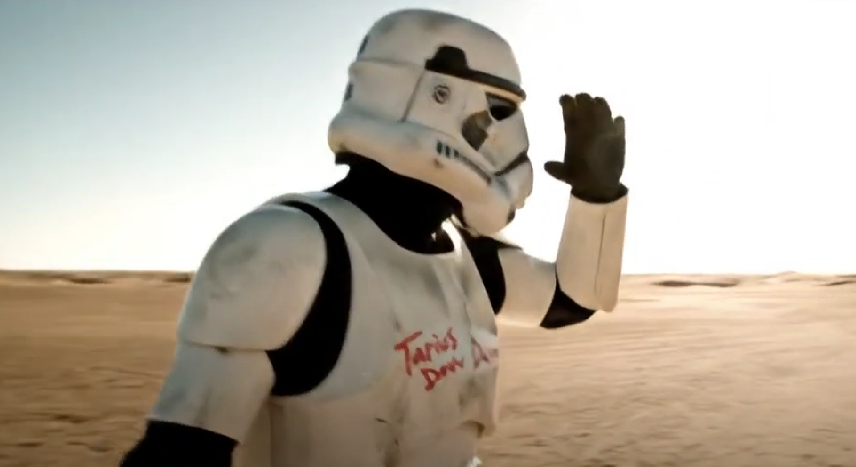 Stormtrooper exits escape pod to sand.